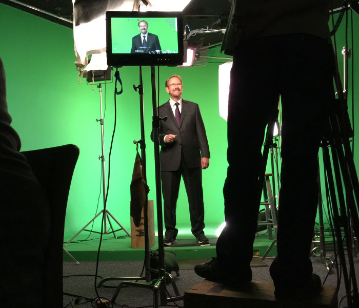 Daniel Burrus behind the camera with green screen behind him