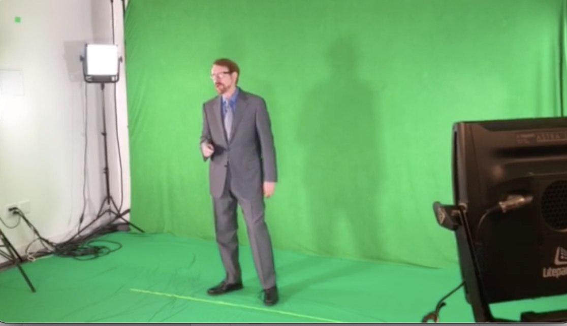 Daniel in front of a green screen and as a hologram on stage at live event